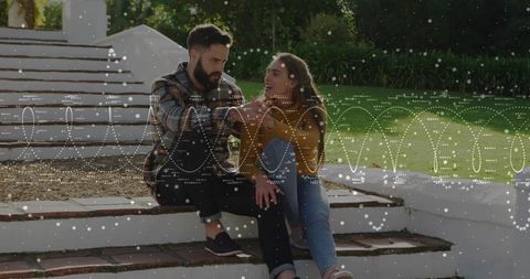 Couple in plaid and mustard sitting on white steps holding hands with dotted overlay