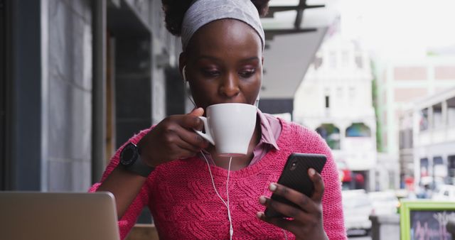 Young woman drinking coffee while using smartphone at outdoor cafe - Download Free Stock Images Pikwizard.com