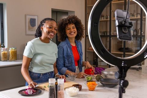 African American Creators Filming Cooking Tutorial Chopping Vegetables in Modern Kitchen