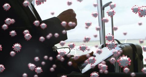 Business traveler with digital tablet amidst pandemic alert