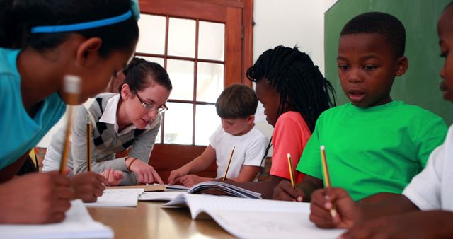 Teacher interacting with diverse group of students in classroom - Download Free Stock Images Pikwizard.com