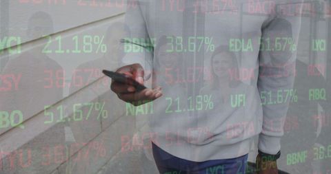 Man Engaging with Stock Market Data on Smartphone Outdoors