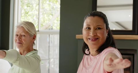 Senior women practicing yoga at home with natural light