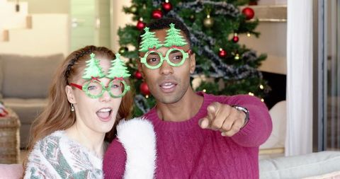 Couple enjoying christmas celebration with festive tree glasses