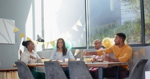 Multiracial friends toasting at birthday party celebration