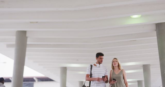 Young Couple Strolling and Chatting in Modern Architectural Building - Download Free Stock Images Pikwizard.com