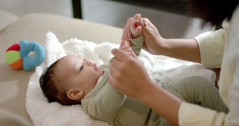 Mother Engaging Baby with Affectionate Interaction on Couch