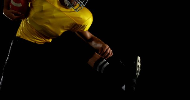 Image captures intense moment with American football player running while holding football, ideal for sports-related themes, promotional materials for football games, training, teamwork motivation, and athletic posters.