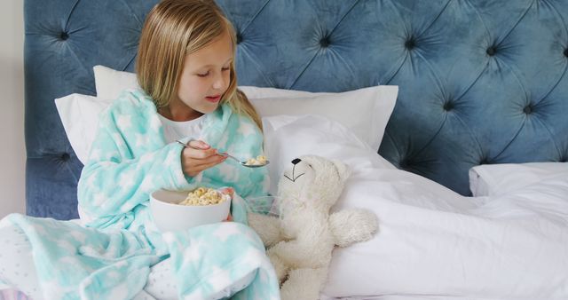 Cozy Morning: Girl in Pajamas Enjoying Cereal with Teddy Bear - Download Free Stock Images Pikwizard.com