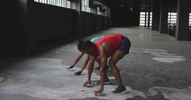 Athletic individuals performing high-intensity workout in industrial gym - Download Free Stock Images Pikwizard.com