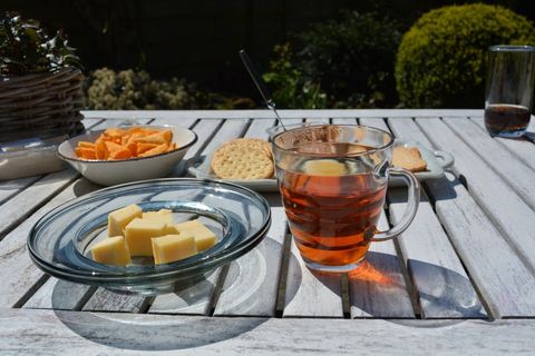 Outdoor tea time with snacks on rustic table