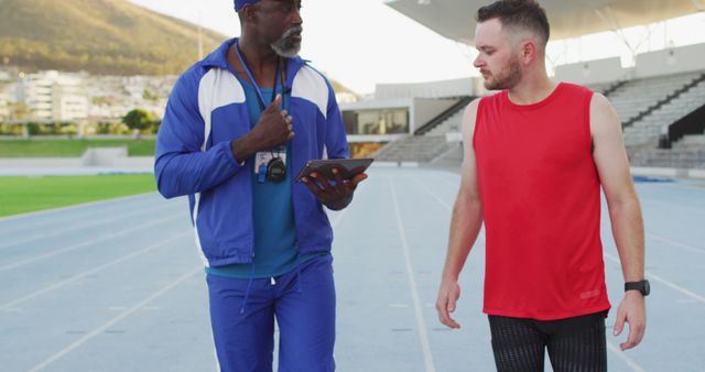 Athlete Training with Coach on Outdoor Track - Download Free Stock Images Pikwizard.com