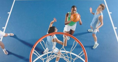 Diverse Female Athletes Competing in Intense Basketball Game