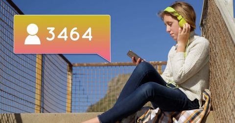 Influencer in Headphones Checking Followers Growth on Social Media