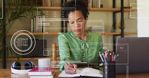 Woman Writing in Notebook with Digital Data Interface