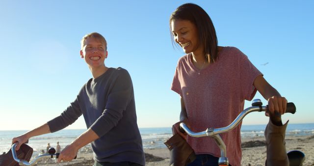 Young Couple Enjoying Bike Ride on Beach - Download Free Stock Images Pikwizard.com