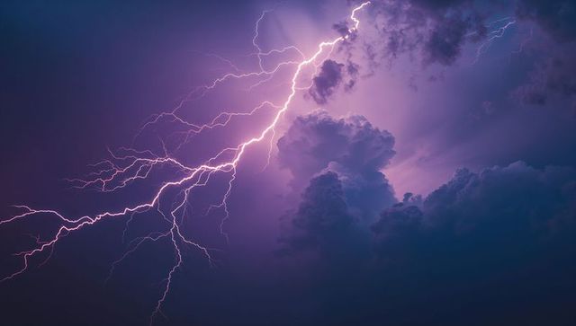 Striking lightning bolt through purple sky with clouds