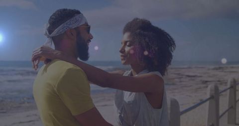 Romantic Couple Embracing on a Beach Walkway at Sunset