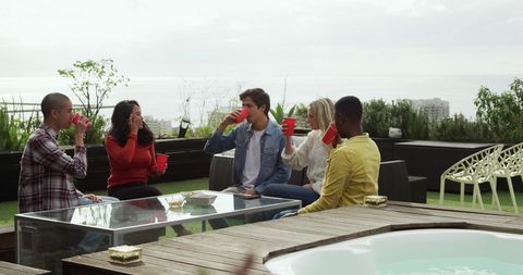 Friends Enjoying Drinks on Modern Rooftop Patio - Download Free Stock Images Pikwizard.com