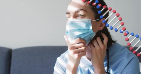 Nurse adjusting surgical mask with dna helix overlay in sunlit clinical portrait