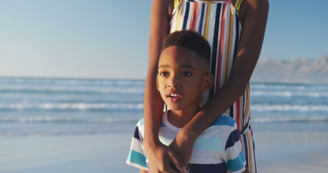 Mother and Child Relaxing on Beach with Sunlight - Download Free Stock Images Pikwizard.com