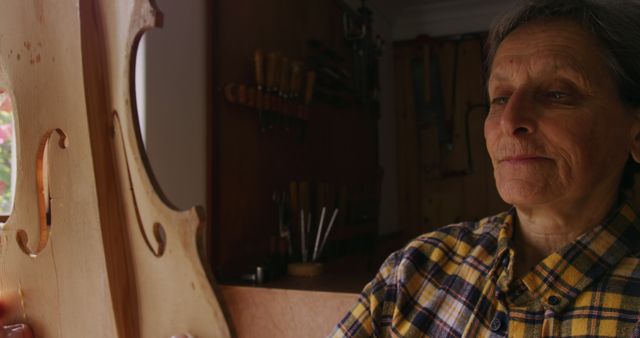 Senior Artisan Inspecting Wooden Musical Instrument in Workshop - Download Free Stock Images Pikwizard.com