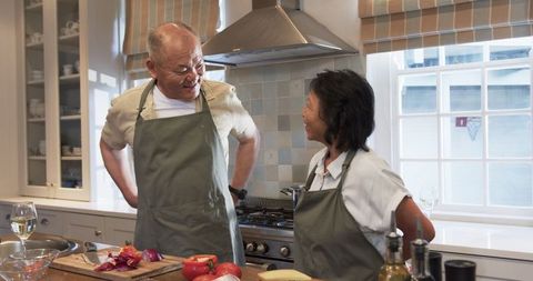 Senior Couple Sharing a Joyful Cooking Experience at Home
