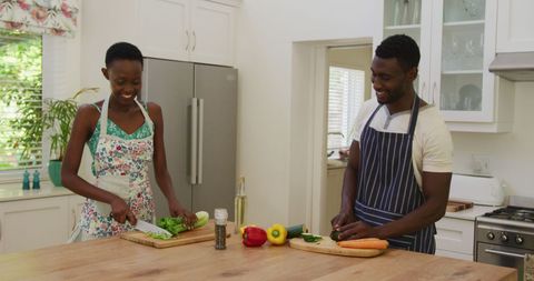 Happy Culinary Couple Preparing Meal Together in Bright Kitchen