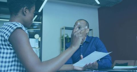Pointing colleague gesturing while manager reviewing document during tense office meeting