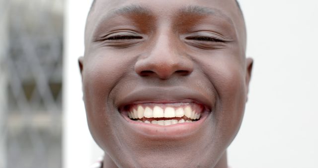 Happy african american man face close up smiling at camera. Masculinity, expression and domestic life, unaltered.