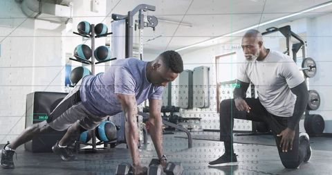 Trainer coaching athlete doing renegade dumbbell row plank with performance data overlay