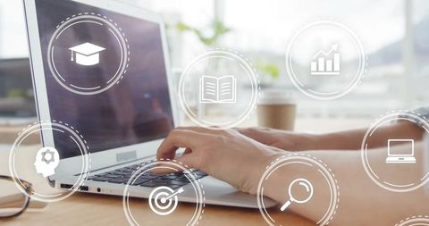 Hands typing on laptop with digital education and business icons overlay