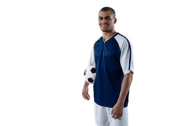 Smiling football player holding football against white background