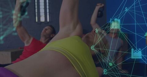 Woman Pressing Kettlebell Overhead During Group Strength Training with Tech Data Overlay