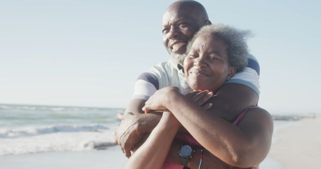 Happy Elderly Couple Embracing on Beach During Sunset - Download Free Stock Images Pikwizard.com