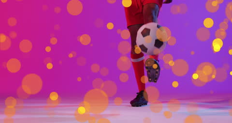 African American Soccer Player Dribbling with Vibrant Bokeh Effects