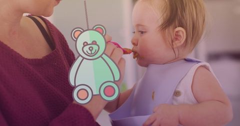 Mother Feeding Baby During Weaning Week with Teddy Bear Icon