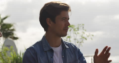Man Talking on Rooftop Terrace on Cloudy Day