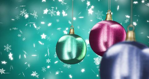 Colorful Christmas Baubles Among Falling Snowflakes