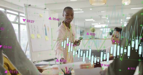 Diverse team collaborating with financial analytics in modern office