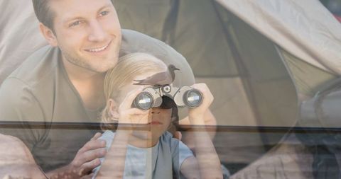 Father and Son Bird Watching with Binoculars by Tent
