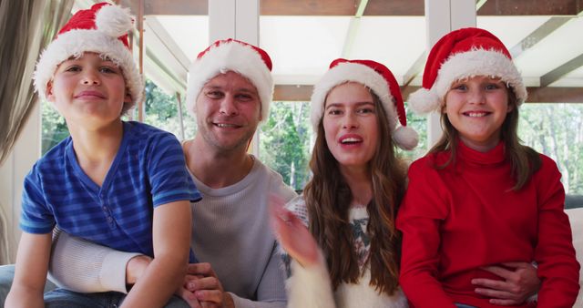 Happy Family Celebrating Christmas Together Wearing Santa Hats - Download Free Stock Images Pikwizard.com