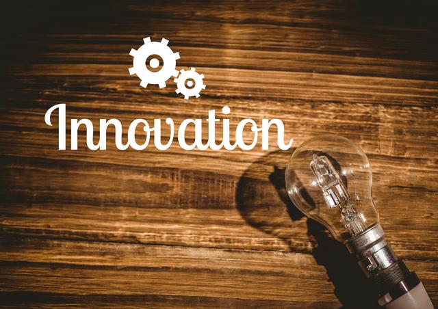 This image depicts the word 'Innovation' alongside a light bulb on a wooden background, symbolizing creativity and new ideas. It is ideal for use in presentations, websites, and marketing materials related to technology, business development, and creative solutions.