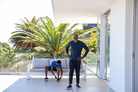 Father and Son Preparing for Outdoor Exercise on Modern Terrace