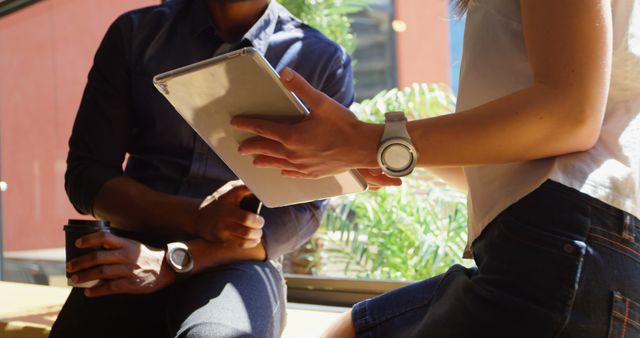 Colleagues Analyzing Data on Tablet in Sunlit Office - Download Free Stock Images Pikwizard.com