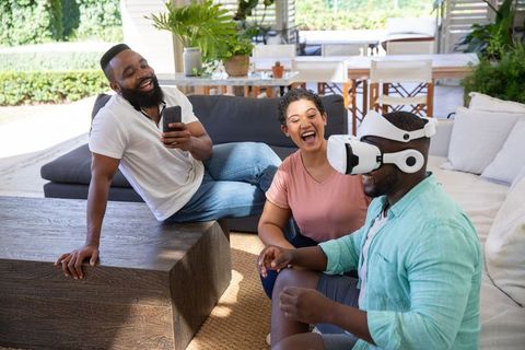 Diverse Friends Enjoying Virtual Reality Together Outdoors