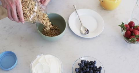 Healthy Breakfast Preparation with Granola and Fresh Berries