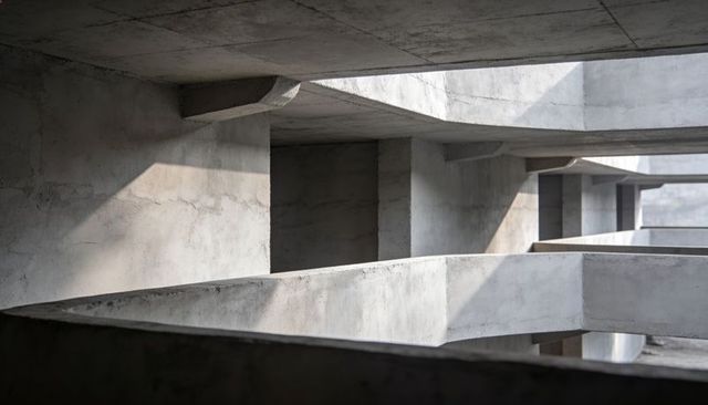 Monolithic Brutalist Concrete Interior Receding Slabs and Beams with Geometric Light Shafts