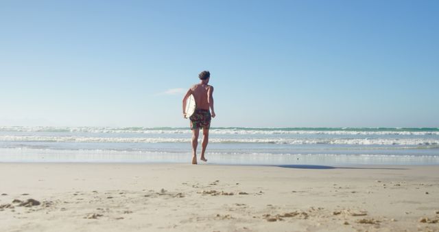 Surfer Running Toward Ocean on Sandy Beach - Download Free Stock Images Pikwizard.com