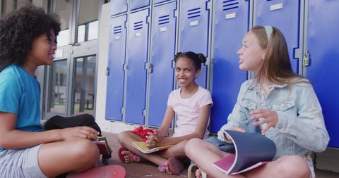 Diverse Schoolgirls Socializing in School Corridor